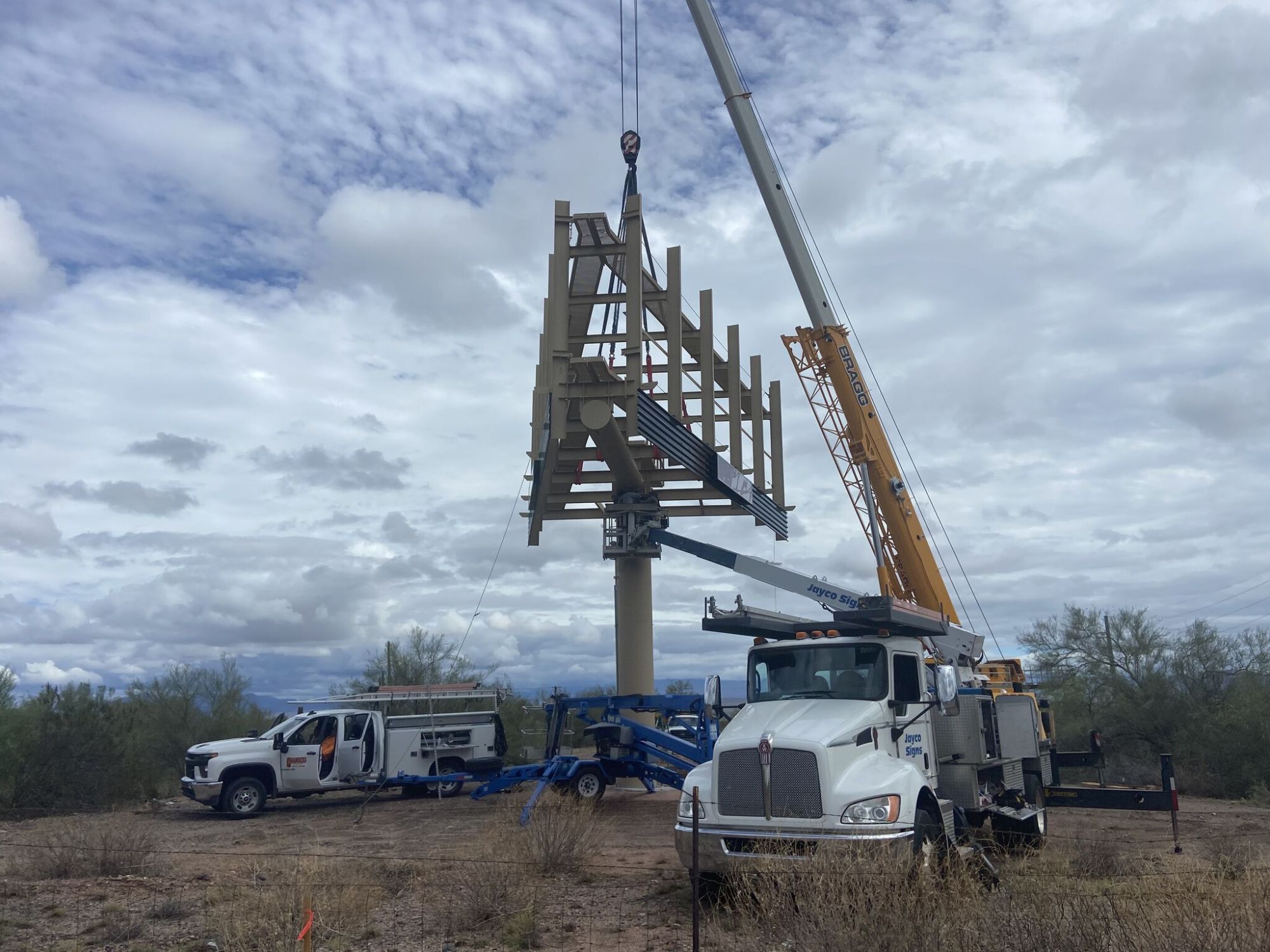 Crane lifting a new Frame billboard structure onto its pole